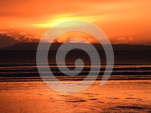 Dark orange sunset at East Wittering with yellow patch of light