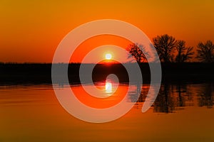 Dark orange sunset over the river