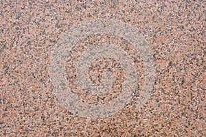 Dark pink granite texture with black splashes.