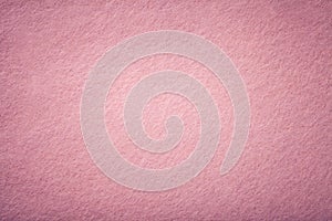 Light pink matt suede fabric closeup. Velvet texture of felt photo