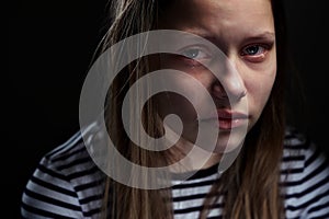 Dark portrait of a depressed teen girl