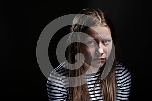 Dark portrait of a depressed teen girl