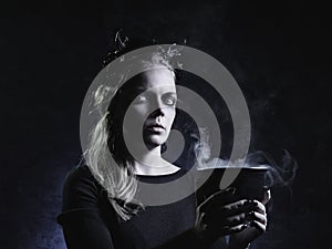 Dark portrait of evil witch in smoke
