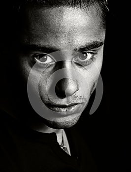 Dark portrait - face of one expressive man photo