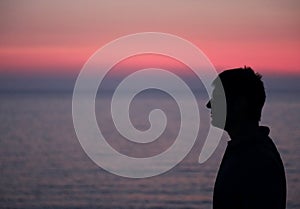 Dark profile of man with glasses and the background of a beautif photo