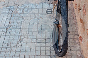 A dark punctured and damaged bicycle wheel