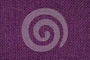 Dark purple background from woolen texture textile, closeup. Structure of the wicker fabric macro.