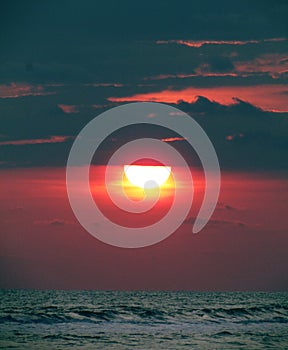 Dark powerfull sunset on the beach photo