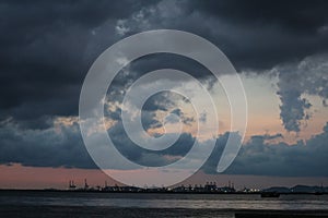 Dark rain cloud sky on sea the city seaport