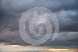 Dark rain clouds in the evening sky. Dramatic sky with an coming cloud