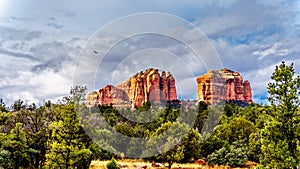 Dark rain clouds over the colorful layers of Cathedral Rock, one of the many well known red rocks near Sedona, Arizona