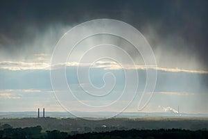 Dark rainy clouds over a coal power plant - smog over a industrial zone