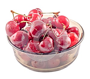 Dark-Red cherries in a brown transparent bowl, isolated, white background