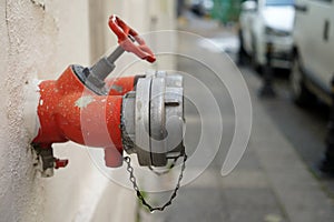 A Dark Red Fire Hydrant Sits Inside An Old Wall