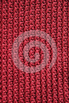 Dark red knitted material texture background. Top view. Copy, empty space for text