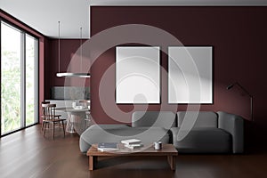 Dark red living room and kitchen interior with posters