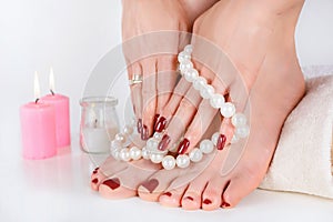 Dark Red Manicure and Pedicure with Pearls and Candles