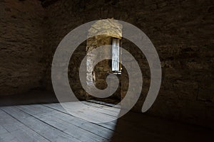 Dark room with stone walls and window