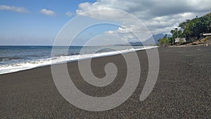 Dark sand beach in aimere