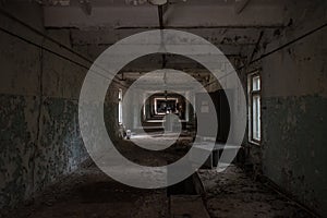 Dark, scary, collapsed, abandoned, old. creepy, room with windows covered in the building located in the Chernobyl ghost town