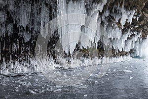 Dark and scary icicles in the a cave and broken ice pieces.