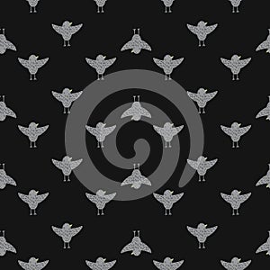 Dark seamless pattern with grey flying birds shapes ornament. Brown background