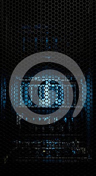 Dark server rack with glowing blue light. Modern data center storage and cloud computing infrastructure. Network security concept