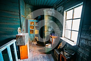 Dark and shabby messy room in poor apartment of old emergency abandoned wooden house, poverty concept