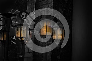 Dark shot taken of a lamp post with glowing lights