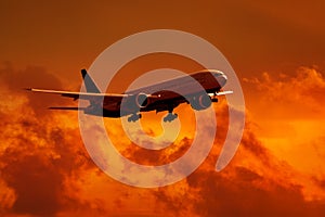 Dark silhouette of aircraft against a red sky