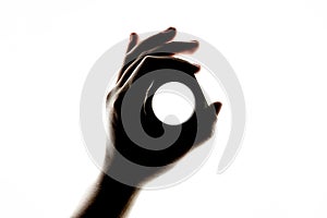 Dark silhouette of female hand holding a large industrial hex nut fastener and making the OK hand sign gesture - Body