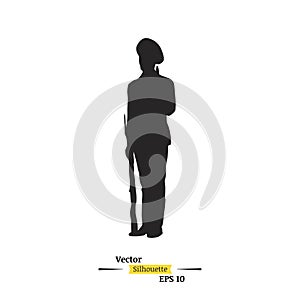 Dark silhouette of a soldier with a rifle on a white background. A soldier stands on a post. Flat illustration EPS 10