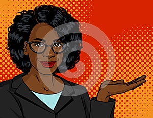 Dark skin woman in a business suit and glasses shows something.