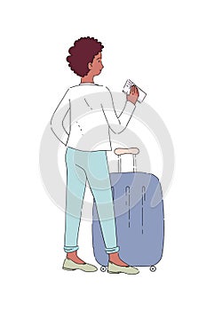 Dark-skinned girl with luggage and a suitcase on wheels stands with boarding pass and waits for her ticket control. Passenger