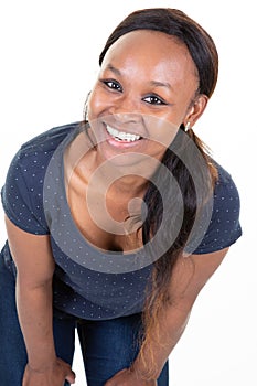 Dark-skinned woman dressed casually smiling joyfully showing her white straight teeth