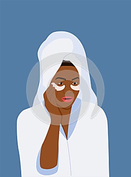 Dark-skinned young woman towel puts patches on her face.