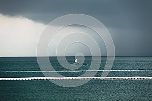 Dark sky cloud rain strom in the sea photo