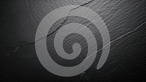 Dark and sleek black texture surface background with subtle shadow in corners