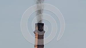 Dark smoke of old factory smokestack