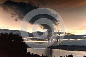 Dark smoke and pollution from coal power plant chimneys darken the sky