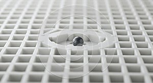 Dark Sphere Centered on White Geometric Grid Surface