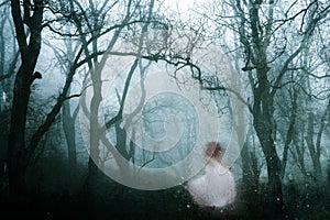 A dark, spooky forest with a ghostly womanin a white dress, on a cold foggy winters day. With an old artistic vintage edit