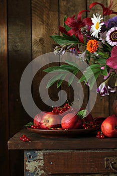 dark still life with nectarines and red currants on a clay bowl, ripe garden berries.
