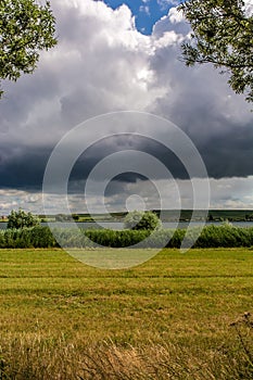 Dark storm cloud over rural region