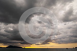 Dark storm cloud over the sea in sunset or sunrise sky Dramatic black cloudscape