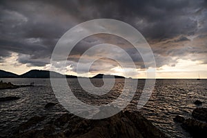 Dark storm cloud Rain clouds over sea in sunset or sunrise sky Dramatic black cloudscape in bad weather day Horrible weather day