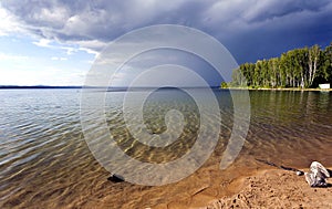 Dark storm clouds before rain above the lake