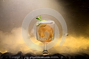 dark and stormy rum cocktail with Lime against background of smoke