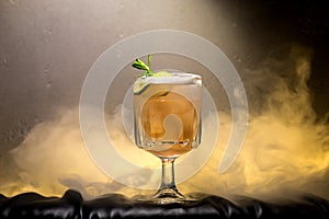 dark and stormy rum cocktail with Lime against background of smoke