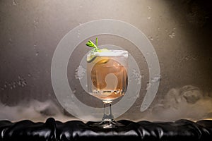 dark and stormy rum cocktail with Lime against background of smoke